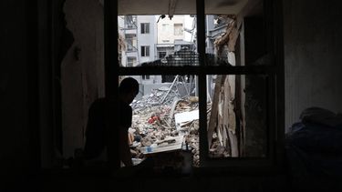 epa12821305 An Iranian person collects belongings from a damaged residential building in southern Tehran, Iran, 15 March 2026. A joint Israeli and US military operation continues to target multiple locations across Iran since the early hours of 28 February 2026.  EPA/ABEDIN TAHERKENAREH