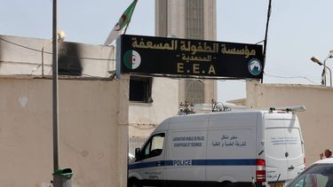 epa13114480 A police van enters the premises of an orphanage affected by a fire, in the Algiers suburb of Mohammadia, Algeria, 16 July 2026. At least 11 children lost their lives and 19 others were injured in the fire that broke out early on 16 July, according to Algerian Civil Protection agency.  EPA/MOHAMED MESSARA