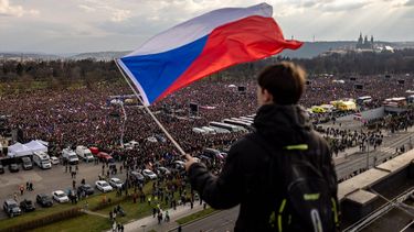 epa12839326 A protester holds a Czech flag as crowds gather at Letna Plain for the 'We Will Not Let Our Future Be Stolen' anti-government demonstration, in Prague, Czech Republic, 21 March 2026. According to the organizers Million Moments for Democracy, the mass protest drew hundreds of thousands to defend democratic values and civic engagement while pushing back against media pressure, defense cuts, and the erosion of state institutions.  EPA/MARTIN DIVISEK