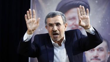 epa11385136 Former Iranian president Mahmoud Ahmadinejad, standing in front of a picture of late Iranian president Ebrahim Raisi, greets media after registering his candidacy during the registration for the Iranian presidential election at the interior ministry in Tehran, Iran, 02 June 2024. Iran will hold presidential election on 28 June 2024.  EPA/ABEDIN TAHERKENAREH