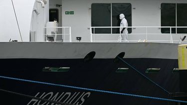A person wearing a protective suit walks aboard the Dutch Hantavirus-hit cruise ship MV Hondius after arriving at the port of Rotterdam on May 18, 2026. A cruise ship that sparked global alarm after a deadly outbreak of hantavirus docked in Rotterdam harbour on May 18, with the skeleton crew facing weeks of quarantine.
NICOLAS TUCAT / AFP