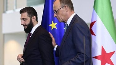 German Chancellor Friedrich Merz (R) and Syrian President Ahmed al-Sharaa leave after a joint press conference after talks at the Chancellery in Berlin on March 30, 2026.  Syria's President Ahmed al-Sharaa visits Germany on Monday for talks on the Middle East war, rebuilding his country and Berlin's efforts to send back Syrian refugees.
John MACDOUGALL / AFP