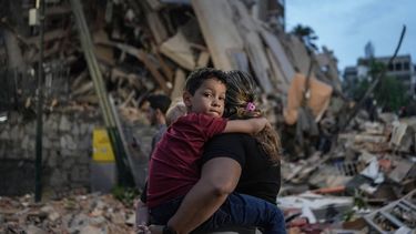 People walk past a collapsed building following an earthquake in Caracas on June 25, 2026. Powerful twin earthquakes have killed 32 people and injured more than 700, the nation's interim president said on June 25, after the massive shocks collapsed entire buildings and sent people running in panic.
Manaure QUINTERO / AFP