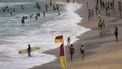People swim and walk along Bondi Beach on a hot and windy spring day in Sydney on October 22, 2025. 
DAVID GRAY / AFP
