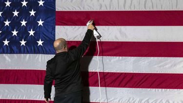 epa10484201 A person steams an American flag before an event with US Vice President Kamala Harris and Marcia Fudge, secretary of Housing and Urban Development (HUD), at Bowie State University in Bowie, Maryland, USA, 23 February 2023. Photographer: Sarah Silbiger/Bloomberg  EPA/Sarah Silbiger / POOL
