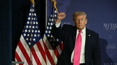 US President Donald Trump (R) makes a fist after a roundtable discussion on his 