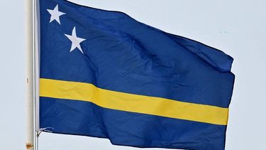 The Curacao flag is seen in Willemstad, Curacao, in the Dutch Caribbean, on April 8, 2026.  Small island, big dreams. The poster of Curacao’s national football team hangs at the entrance of Marchena, a working-class neighborhood of Willemstad, the capital of the smallest territory ever to qualify for a World Cup.
Raul ARBOLEDA / AFP
