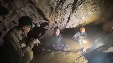 This screengrab made from handout video footage taken on May 29, 2026, and provided by Benz Norrased Palasing of Seascout Diving, shows a rescue team (C, R) about to free one (L) of seven men trapped in a semi-submerged cave in central Xaysomboun province, northeast of the capital Vientiane. A rescue team freed on May 29, one of seven men trapped inside a semi-submerged cave in Laos for more than a week, the group working at the site said.
HANDOUT / Benz Norrased Palasing / Seascout Diving / AFP