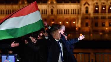 Peter Magyar, leader of the pro-European conservative TISZA party, waves the national flag on the banks on the river Danube with the Parliament building in the background, during their election night party in Budapest during the general election in Hungary, on April 12, 2026. Polls closed in Hungary's parliamentary election, with turnout reaching a record high in the crunch vote that sees nationalist Prime Minister Viktor Orban's 16-year stint in power face an unprecedented challenge from conservative political newcomer Peter Magyar.
Ferenc ISZA / AFP