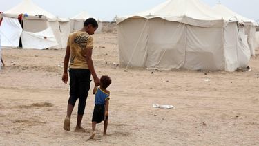 epa13246536 A displaced man and his brother walk through a makeshift camp for Internally Displaced Persons (IDPs) in the southern port city of Aden, Yemen, 17 September 2026. At least 125,000 Yemenis have been displaced over the past two weeks amid the country’s renewed fighting between Houthi forces and Saudi-backed government forces, according to the UN Office for the Coordination of Humanitarian Affairs (OCHA).  EPA/NAJEEB MOHAMED