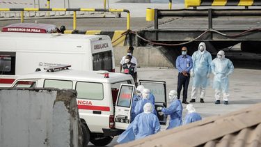 Health personnel returning from the cruise ship MV Hondius, are seen at the port of Praia, the capital of Cape Verde, as individuals wearing hazmat suits are helped into an ambulance on May 6, 2026. Evacuations were taking place on May 6, 2026 from a cruise ship stricken with a deadly outbreak of hantavirus, the World Health Organization said, as experts confirmed a rare strain that can be transmitted between humans.
Three people, two crew members and one other person, thought to be infected with the virus were being taken off the MV Hondius, anchored off Cape Verde, the WHO said. 

AFP