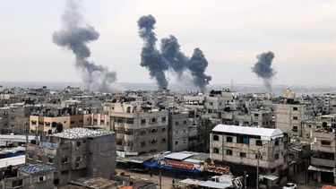 A picture taken on December 20, 2023, from Rafah shows smoke billowing after Israeli strikes over the Nuseirat refugee camp in the central Gaza Strip, amid ongoing battles between Israel and the militant group Hamas. 
MAHMUD HAMS / AFP
