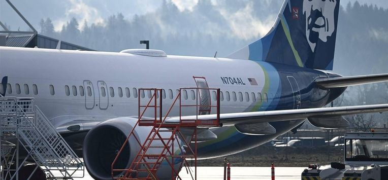 (FILES) Alaska Airlines N704AL, a 737 Max 9, which made an emergency landing at Portland International Airport on January 5 is parked at a maintenance hanger in Portland, Oregon on January 23, 2024. The missing emergency door is covered and taped. Aviation giant Boeing has been unable to produce key information about work performed on an Alaska Airlines plane before a January mid-air scare, said the National Transportation Safety Board chair in a letter on March 13, 2024. Patrick T. Fallon / AFP