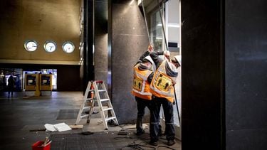 EINDHOVEN - In station Eindhoven Centraal wordt het gesneuvelde glas vervangen. Bij de rellen die uitbraken tijdens een demonstratie tegen de coronamaatregelen werd onder meer het station zwaar vernield. ANP KOEN VAN WEEL