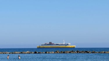 Tourists swim as a Levante Ferries passenger vessel is stationed off the southern Cypriot port city of Limassol in the east Mediterranean on August 13, 2024. 
Ian TIMBERLAKE / AFP