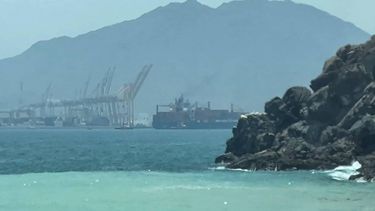 This frame grab taken from AFPTV video footage on July 12, 2026 shows a ship sailing near the Strait of Hormuz off the eastern coast of the United Arab Emirates at Khor Fakkan. Tehran announced it was closing the Strait of Hormuz on July 12 and launched missiles and drones at its Gulf neighbours, in retaliation for new US strikes following an attack by Iranian forces on a merchant vessel that was abandoned in flames by its crew.
AFPTV / AFP