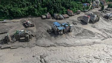 Houses lie partially submerged in muddy water along a riverside after flash floods at Trishuli Bazar in Nepal's Nuwakot district on August 26, 2026. A massive flood swept through Nepal's northern Rasuwa district on August 26, damaging roads and power infrastructure as authorities scrambled to assess the scale of the destruction.
Prabin RANABHAT / AFP