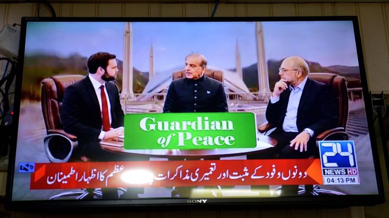 epa12882356 Vice President of the United States JD Vance (L) with Pakistani Prime Minister Shehbaz Sharif (C) and Iran's parliamentary Speaker Mohammad Bagher Ghalibaf (R) appear on a television screen during US-Iran talks, in Peshawar, Pakistan, 11 April 2026. An Iranian and US delegation arrived in Islamabad for planned peace talks amid a fragile two-week ceasefire following the conflict that began on 28 February 2026.  EPA/BILAWAL ARBAB