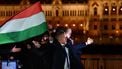 Peter Magyar, leader of the pro-European conservative TISZA party, waves the national flag on the banks on the river Danube with the Parliament building in the background, during their election night party in Budapest during the general election in Hungary, on April 12, 2026. Polls closed in Hungary's parliamentary election, with turnout reaching a record high in the crunch vote that sees nationalist Prime Minister Viktor Orban's 16-year stint in power face an unprecedented challenge from conservative political newcomer Peter Magyar.
Ferenc ISZA / AFP