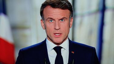 French President Emmanuel Macron is seen on a screen as he delivers his televised New Year's address to the nation from the Elysee Palace, in Paris on December 31, 2024. 
Kiran RIDLEY / AFP
