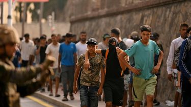 A Spanish soldier monitors a group of migrants on their way back towards the Moroccan border, following their illegal crossing into the Spanish enclave of Ceuta, on August 1, 2026. At least 67 people have died in a recent surge of migrant crossings from Morocco to Spain's North African enclave of Ceuta, Spain's Interior Minister said today. Most of the 60,000 migrants who entered Ceuta over the space of a few days from neighbouring Morocco have already returned to Morocco.
JORGE GUERRERO / AFP