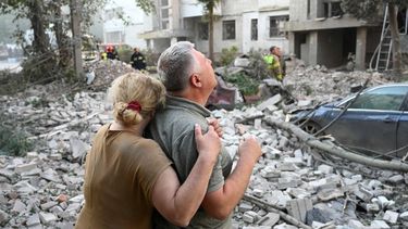 Local residents react outside a residential building partially destroyed as a result of Russian missile strikes in the western Ukrainian city of Lviv on July 30, 2026, amid the Russian invasion in Ukraine. Officials in Ukraine's eastern Poltava region, meanwhile, said one person was killed in a drone strike on a warehouse, while at least 15 people were wounded in attacks on the western city of Lviv. Russia launched 74 missiles and 284 drones at Ukraine last night, according to Kyiv on July 30, 2026. 
YURIY DYACHYSHYN / AFP