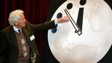 SJO01 - 20020227 - CHICAGO, IL, UNITED STATES : Dr. Leon Lederman, an internationally renowned high-energy physicist, adjusts the hands on the 'Doomsday Clock' two minutes closer to midnight 27 February, 2002 at the University of Chicago. The Doomsday Clock has been used by the Bulletin of Atomic Scientist since 1947 to represent the perceived danger of a catastophic nuclear event. The clock now reads 7 minutes until midnight. EPA PHOTO AFPI/SCOTT OLSON/sjo/eh/ja
