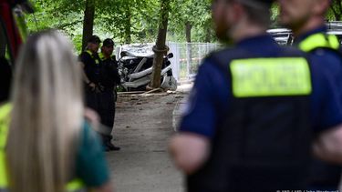 Police work near the wreckage of a car on July 26, 2026 in the Tiergarten park in Berlin, where a car was driven the evening before into people killing one person and injuring 16 on the outskirts of the Christopher Street Day (CSD) parade.
 German police searched on July 26, 2026 for a suspect believed linked to Islamist circles after a car ploughed into a crowd near Berlin's Gay Pride celebrations, killing one person and wounding 16 others. The incident shattered what had been a day of celebration for hundreds of thousands attending Christopher Street Day, one of Europe's largest Pride events, and left revellers fleeing a central Berlin park as sirens echoed through the night.

John MACDOUGALL / AFP
