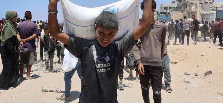People make their way along al-Rashid street in western Jabalia on July 22, 2025, after receiving humanitarian aid from an aid distribution point in the northern Gaza Strip. The head of Gaza's largest hospital on July 22, said 21 children have died due to malnutrition and starvation in the Palestinian territory in the past three days, while Israel pressed a devastating assault.
Omar AL-QATTAA / AFP