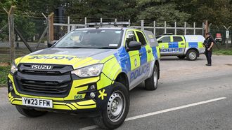 Armed police are posted manning a roadblock at an entrance to RAF Fairford base in Fairford, south-west England on September 27, 2026, as UK counter-terrorism police investigate an incident near the base in the village of Whelford. British police on September 27 declared a major incident and evacuated villagers living near a base used by the US air force after arresting several men on suspicion of explosives offences.
JUSTIN TALLIS / AFP