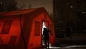 People enter an emergency service tent set up for those whose homes are without electricity or heating following Russian missile and drone attacks on Ukrainian energy infrastructure, in a residential neighborhood of Kyiv on January 22, 2026  amid the Russian invasion in Ukraine. 
Genya SAVILOV / AFP