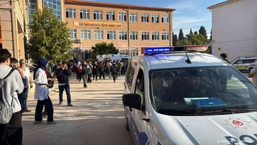 This handout photograph taken and released on September 22,2026 by Turkish news agency DHA (Demiroren News Agency) shows ambulances and police officers waiting in front of a high school outside which a gunman opened fire wounding eight people, and was detained shortly afterwards, in Turgutlu, an area west of the resort city of Izmir. 
Handout / DHA (Demiroren News Agency) / AFP