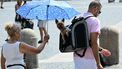 A woman holds an umbrella to shield a dog carried in a backpack from the sun during a heatwave, in the Vatican on August 2, 2026. 

Alberto PIZZOLI / AFP
