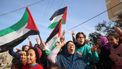 Displaced Palestinians waving national flags cheer as they return to Rafah in the southern Gaza Strip on January 19, 2025, hours after a ceasefire deal in the war between Israel and the Palestinian militant group Hamas was expected to be implemented.  
Eyad BABA / AFP