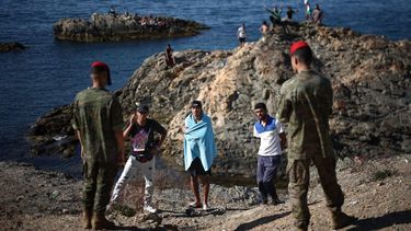 Members of the Spanish Army's 'Regulares' infantry forces speak with a group of migrants near the border post of the Spanish enclave of Ceuta on August 2, 2026. At least 72 people died during last week's mass influx of migrants into Spain's Ceuta enclave, when tens of thousands of people mostly swam around the border post from Morocco, local officials said today. Most of the estimated 60,000 people who rushed into Spain's north African territory have returned to Morocco since the territory's largest mass migrant crossing.
Henry Nicholls / AFP