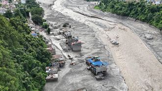 An aerial view shows houses lying deluged in sludge following flash floods in Trishuli of Nepal's Nuwakot district on August 27, 2026. Rescue teams scoured devastated zones August 27 for more than 1,300 people missing a day after flash floods and landslides along the Nepal-Tibet border killed at least 273, sweeping away entire villages.
Arun SANKAR / AFP