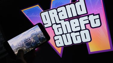 This illustration photo created in Los Angeles, December 4, 2023, shows Rockstar Games’ Grand Theft Auto VI trailer played on a screen in front of the game title. The first trailer for 