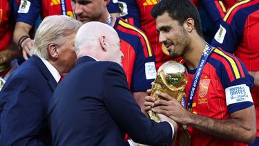 Spain's midfielder #16 Rodri (R) receives the trophy from FIFA President Gianni Infantino (C) and US President Donald Trump (L) after winning the 2026 World Cup football tournament final match between Spain and Argentina at the New York/New Jersey Stadium in East Rutherford on July 19, 2026. 

FRANCK FIFE / AFP