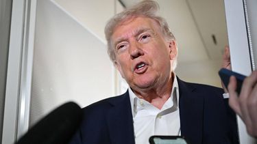 US President Donald Trump speaks to reporters while in flight on Air Force One, en route fo Palm Beach International Airport in West Palm Beach, Florida, on April 11, 2025. 
MANDEL NGAN / AFP