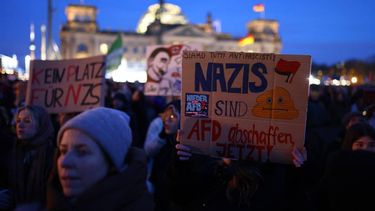 A participant holds up a placard during a demonstration against racism and far right politics in front of the Reichstag building in Berlin, Germany on January 21, 2024. Tens of thousands of people were expected to turn out again on January 21 to protest against the far-right AfD, after it emerged that party members discussed mass deportation plans at a meeting of extremists.
CHRISTIAN MANG / AFP