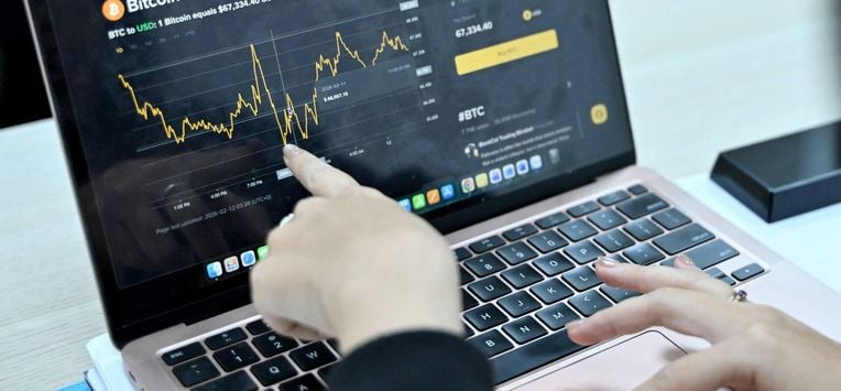 This photo taken on February 12, 2026 shows a Vietnamese cryptocurrency investor looking at the latest Bitcoin values on a laptop in Hanoi. As a first-year computer science student in Hanoi, Hoang Le started trading crypto from his university dorm room, egged on by his gamer friends who were making a killing, and at one point his digital holdings swelled to $200,000 -- around 50 times the average annual income in Vietnam. But they crashed to zero when the bottom fell out of bitcoin and other cryptocurrencies in recent months.

Nhac NGUYEN / AFP