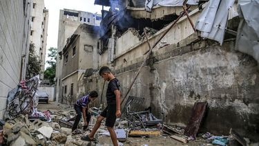 epa13124387 Palestinian youths stand amid the rubble from the destroyed house of the Al-Masri family following an Israeli attack, in Gaza City, Gaza Strip, 21 July 2026. Firas Al-Masri, his wife, Salsabil, and their four children were killed in Gaza City, when the Israeli army targeted their home with a drone early 21 July, according to the Gaza Ministry of Health.  EPA/MOHAMMED SABER
