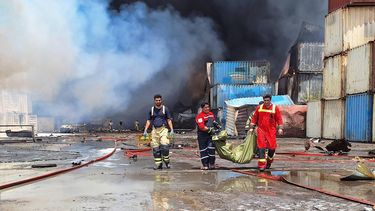 Firefighters carry a victim at the scene of an explosion that took place a day earlier at the Shahid Rajaee port dock, southwest of Bandar Abbas in the Iranian province of Hormozgan, on April 27, 2025. Fire blazed on April 27, around 24 hours after a massive explosion tore through Iran's largest commercial port, killing at least 28 people and leaving more than 1,000 others injured, according to the Red Crescent.

Meysam Mirsadeh / TASNIM NEWS / AFP