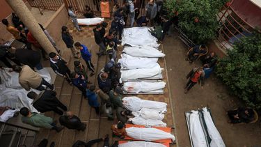 Palestinians mourn the death of loved ones following Israeli bombardment in the southern Gaza Strip on December 5, 2023, as several bodies lie outside a hospital in Khan Yunis, amid continuing battles between Israel and the militant group Hamas. 
Mahmud HAMS / AFP