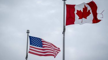 The Canadian and US flags fly near the Canada-US border in Blackpool, Quebec, Canada, on February 2, 2025. Canada will hit back at US tariffs with 25 percent levies of its own on select American goods, Prime Minister Justin Trudeau said on February 1. 