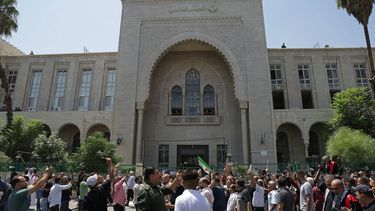 Syrians gather as they celebrate in front of the Palace of Justice after the court proceedings, in Damascus on August 11, 2026. A Syrian court on August 11 sentenced former ruler Bashar al-Assad to death after a trial in absentia, convicting him of atrocities committed during the country's nearly 14-year civil war. It is the first such ruling under Syria's transitional leaders who ousted Assad in December 2024, vowing to provide justice and accountability for crimes committed under his rule.
Bakr ALkasem / AFP