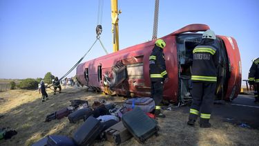 epa13173215 Emergency services attend the scene after a tourist bus travelling from Poland went off the road and overturned in a ditch along the M3 motorway between Mezokeresztes and Mezonagymihaly, Hungary, 16 August 2026. A dozen people were killed and others were seriously injured.  EPA/ZOLTAN MATHE HUNGARY OUT