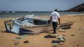 A member of the International Organization for Migration (IOM) inspects the abandoned wreckage of a boat that capsized while attempting to transport migrants to Yemen along the so-called Eastern Route at Gehere beach, near Obock, on April 12, 2026. In Djibouti, dozens of men are making the days-long trek home after their plan to cross one of the world's deadliest migration routes from Africa to the Gulf has failed.
Tens of thousands of migrants brave this so-called Eastern Route each year, most leaving from Djibouti, which lies just 30 km from Yemen at the closest point. 
More than 900 died or disappeared along the route in 2025, the deadliest year on record according to the UN International Organisation for Migration (IOM).
Luis TATO / AFP
