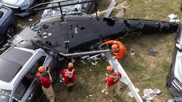 An aerial view shows firefighters working at the site of a helicopter crash in the Recreio dos Bandeirantes neighbourhood in Rio de Janeiro, Brazil, on June 14, 2026. At least six people died in Brazil on June 14 after two helicopters crashed in western Rio de Janeiro, after a suspected mid-air collision, firefighters said.
Tercio TEIXEIRA / AFP