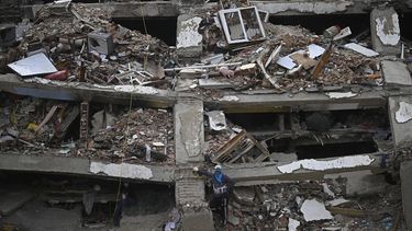 A person stands amid the rubble of a collapsed multi-storey building in Caraballeda, Venezuela, on July 20, 2026, following the June 24 earthquakes. 
Federico PARRA / AFP